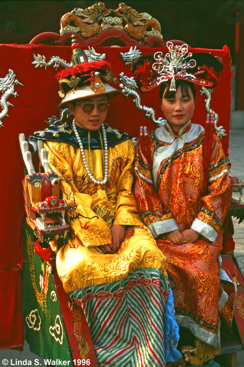 Couple posing in royal costumes for a portrait, Beijing, China