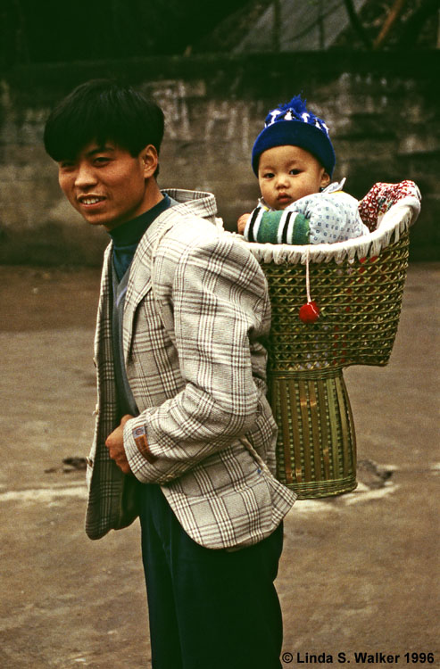 Father with baby in a basket, Dazu, China