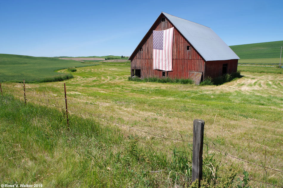 A huge flag flies from an old barn in Thornton, Washington in the Palouse area