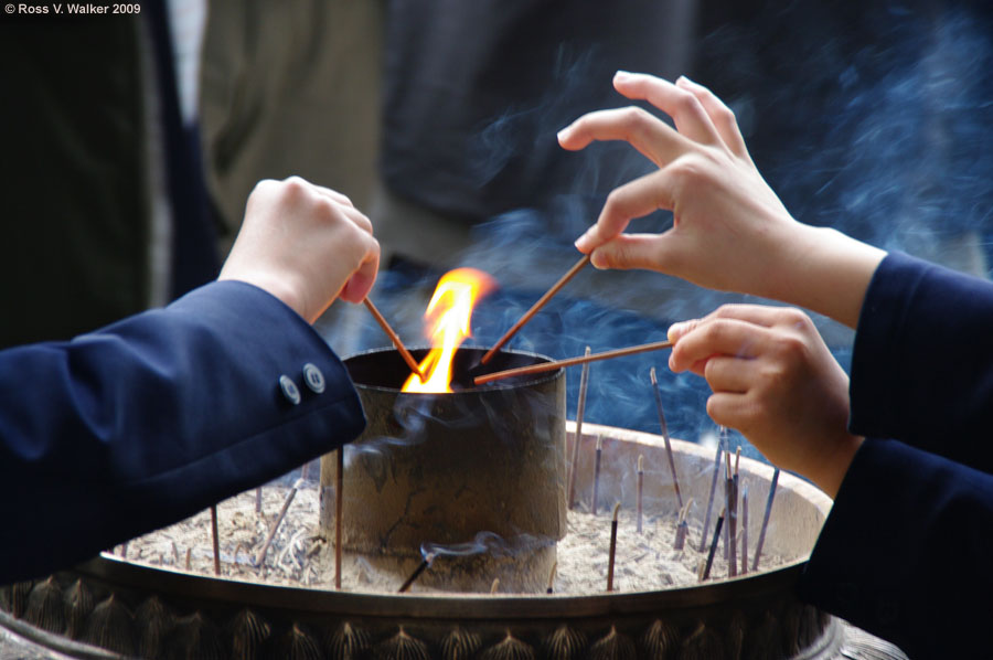 Schoolchildren light incense before visiting Todaiji Temple, Nara, Japan