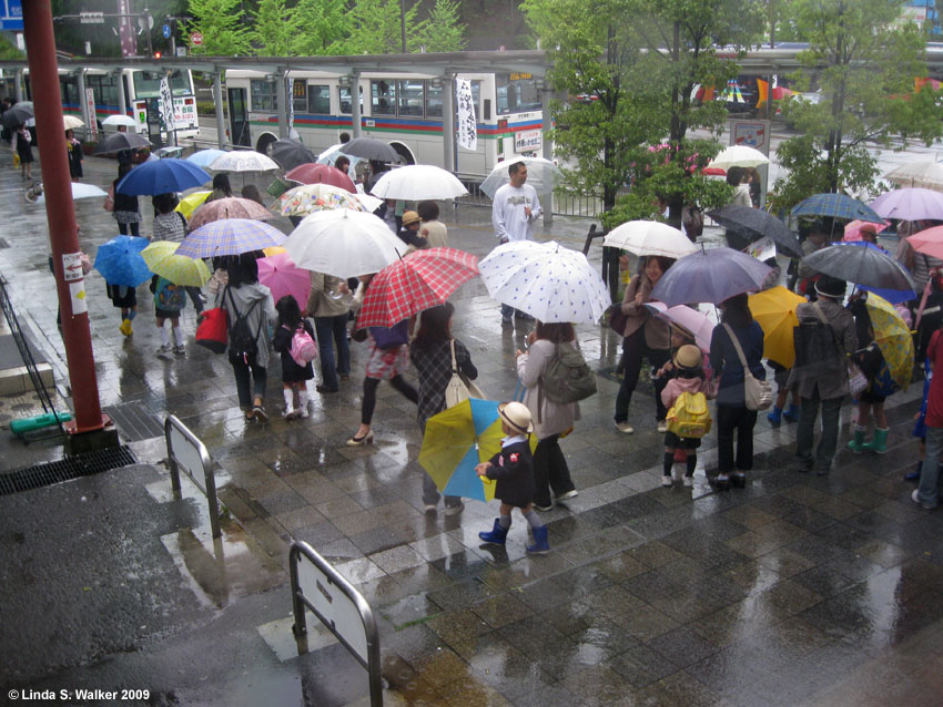 People in the rain at the Odawara train station, Japan