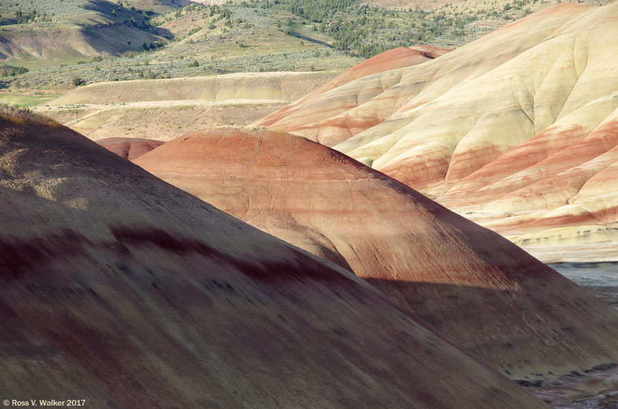 As evening approaches, colors deepen in the shadows at the Painted Hills, Oregon