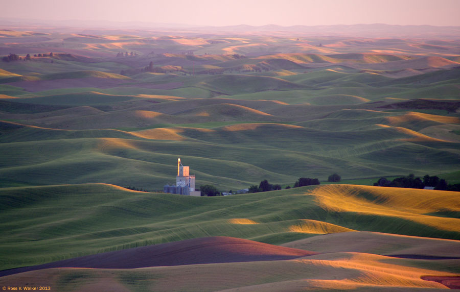 A grain elevator glows in late light at Steptoe Butte State Park, Washington