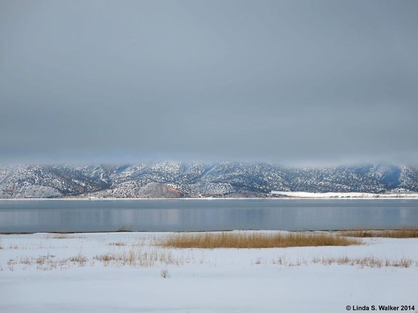 Storm clouds obscure the eastern mountain tops across Bear Lake, Utah.