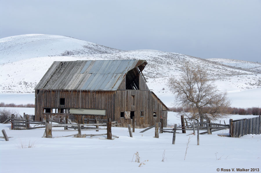 A large barn with gable and shed roof in snowy Nounan, Idaho