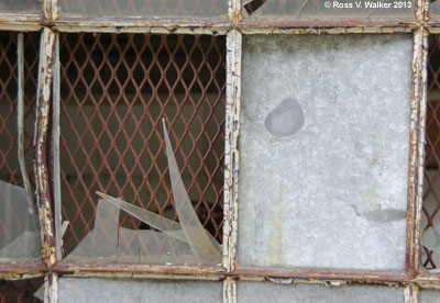 Broken window at the Hecla mining complex in Burke, Idaho