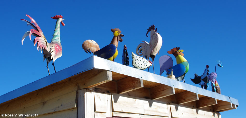 Cheerful hand-crafted chickens greet visitors from a rooftop in Tuscarora, Nevada