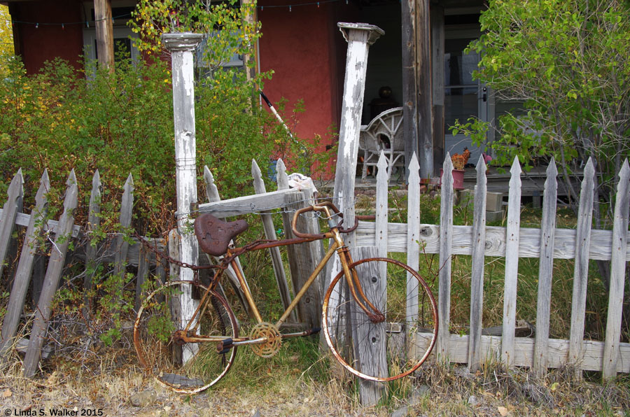 An old bicycle, a rusty chain, and a barbed wire gate at Tuscarora, Nevada
