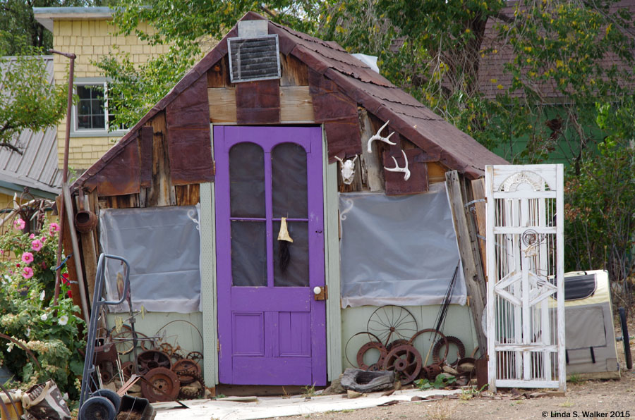 Shed in Tuscarora, Nevada with purple door, and lots of found "art" objects.