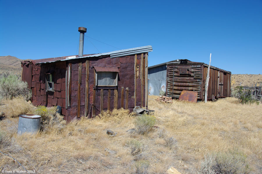 A shack with tin can siding and a matching boxcar at Tuscarora, Nevada