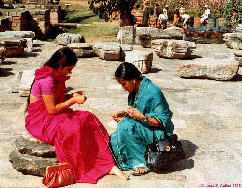 Women winding yarn on their toes, Agra, India