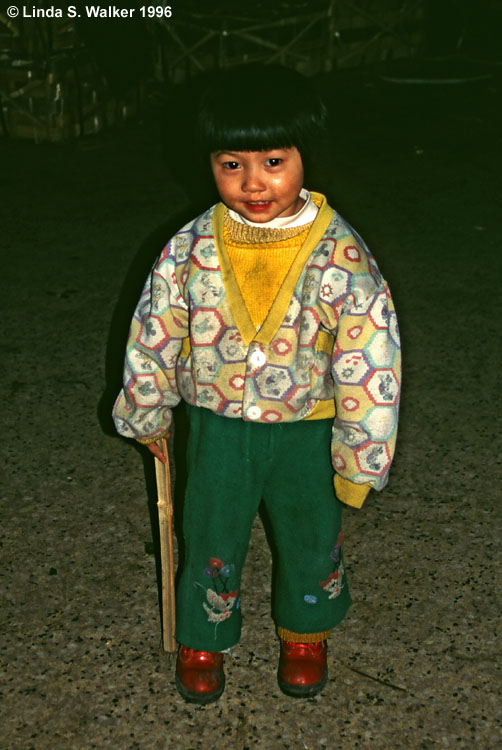 Child at a night market, Chongqing, China