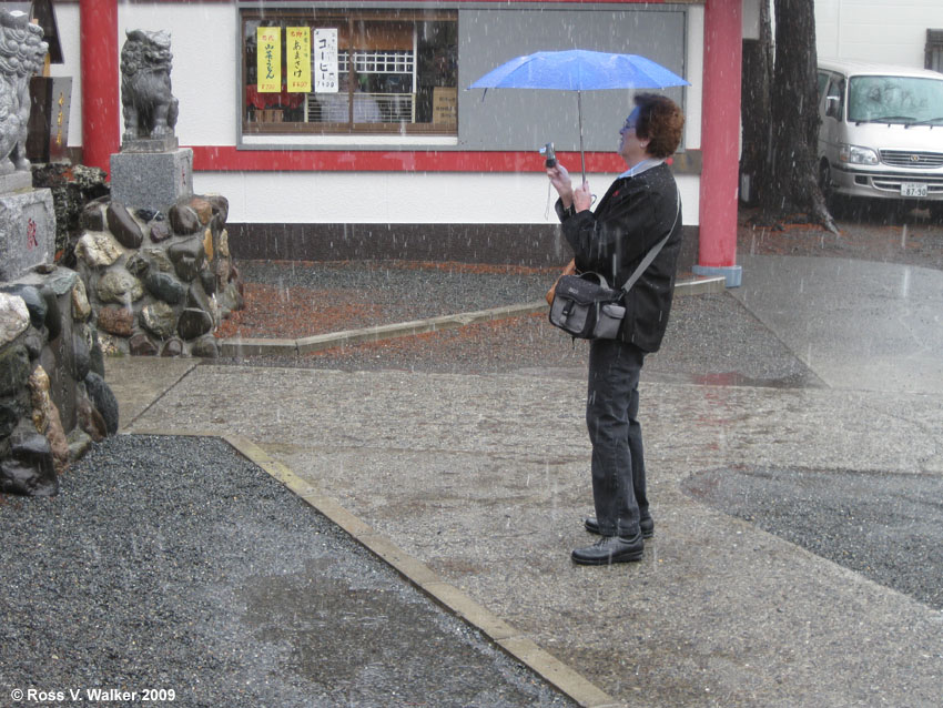 Linda Walker photographing shi-shi dogs in a storm on Mt. Fuji, Japan