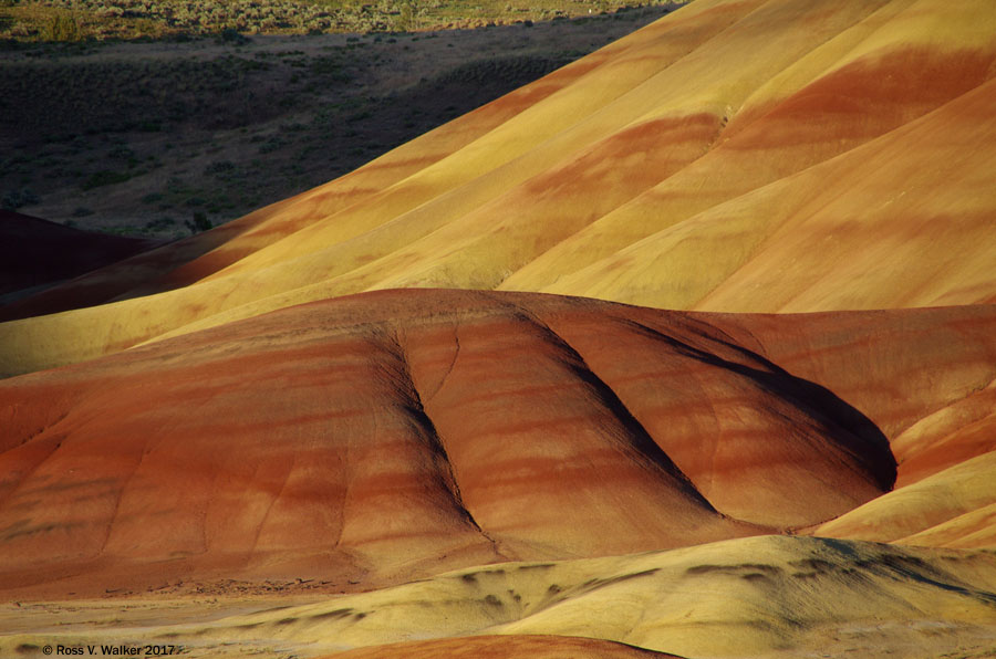 Evening shadows begin to approach the hills, seen from the Painted Hills overlook, Oregon