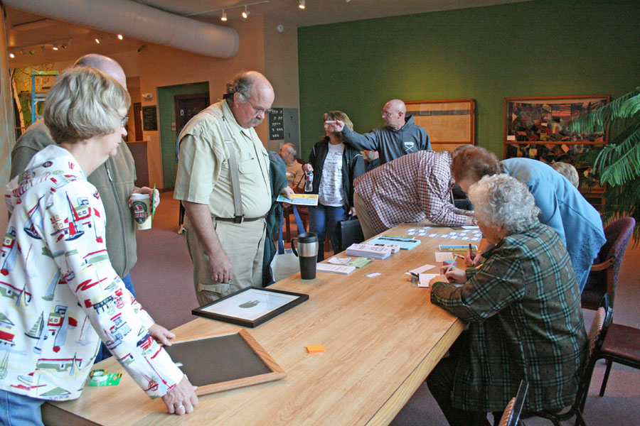 Photo contest registration area, with people entering their photos. 