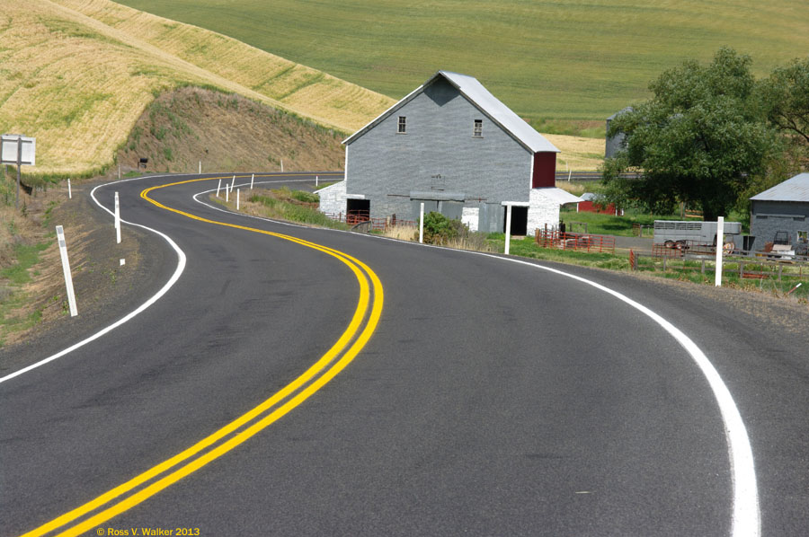 The road had to wrap around this gable roof barn near Colfax, Washington.