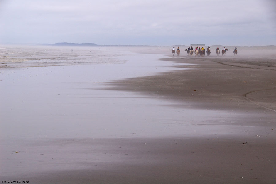 Horseback riders on a foggy beach at Ocean Shores, Washington