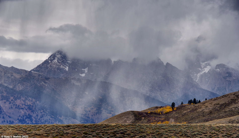 A storm crosses Jackson Hole between the Grand Teton Mountains and Blacktail Butte, Wyoming
