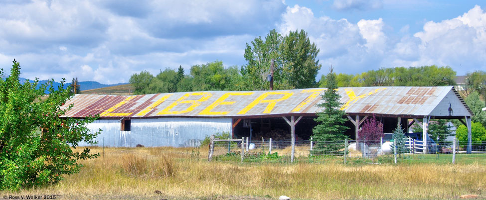 Barn with LIBERTY on one side of the roof and American Flag on the other