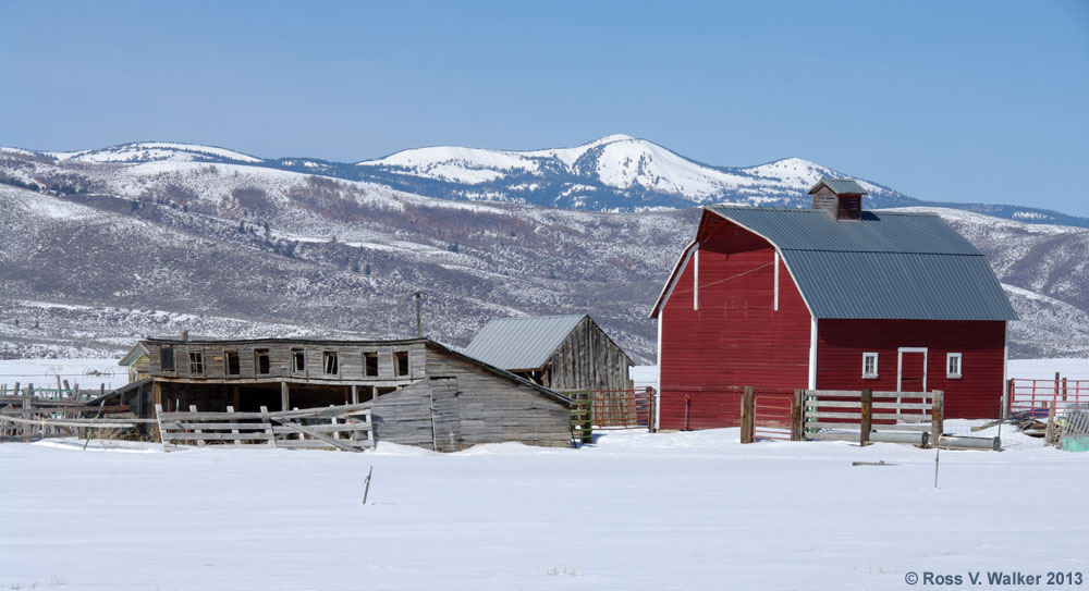 An old lean-to style barn and a gambrel roof bar in Bennington, Idaho