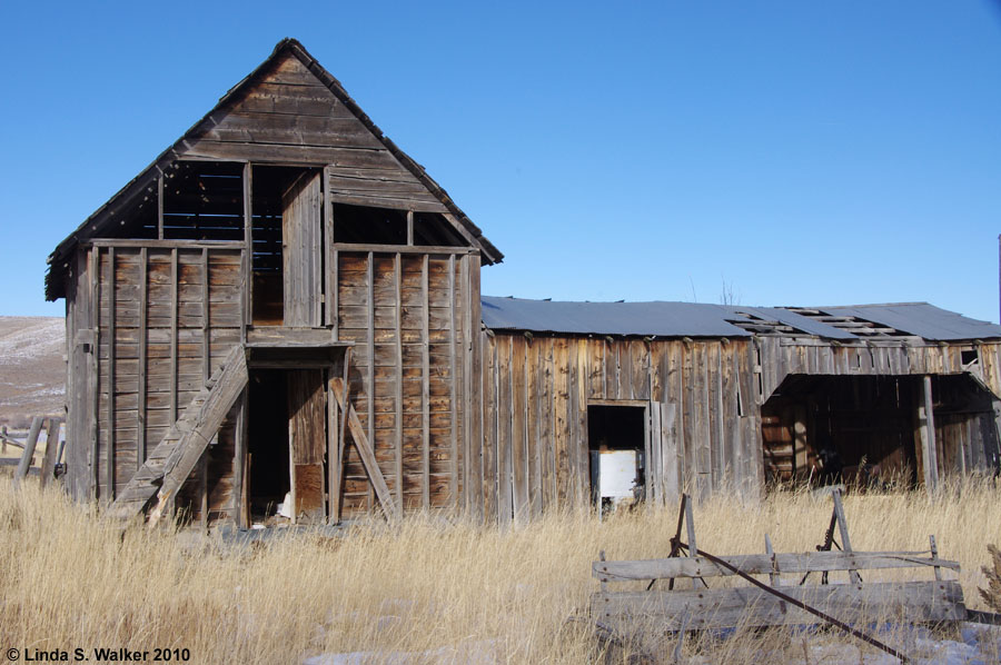 A gable style barn with add-on sheds, in Meadowville, Utah.