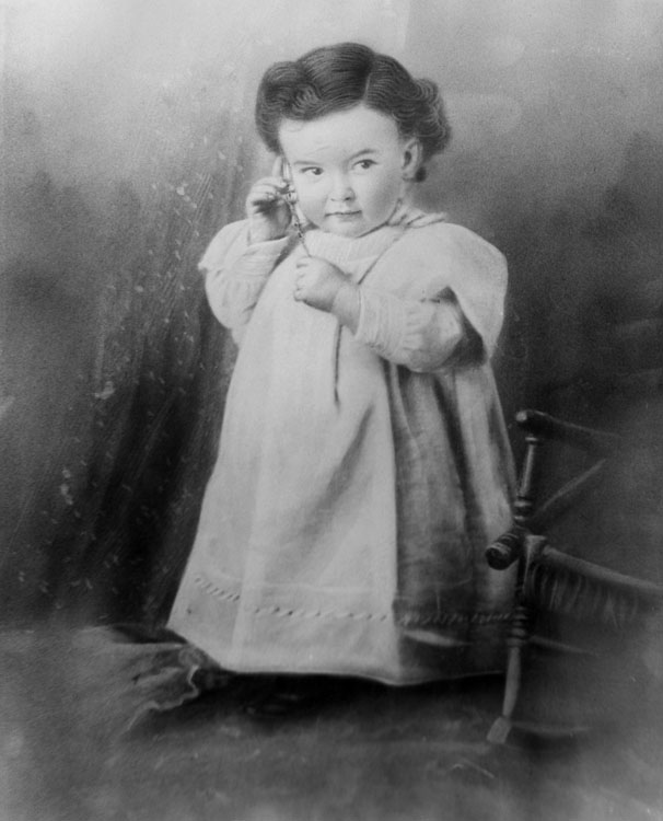 Conover Wright, age 3, listening to his mother's  watch.