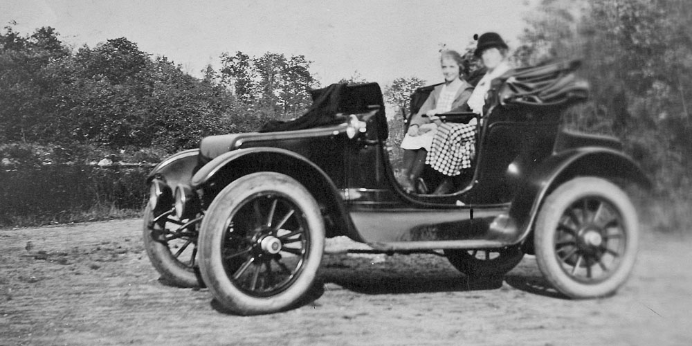 Tannis Marjorie VanDervoort (Walker) learning to drive an electric car about 1918