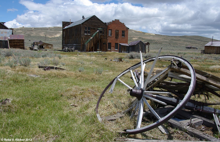 Old wagon wheel behind the I.O.O.F. Hall and the Dechambeau Hotel, Bodie, CA