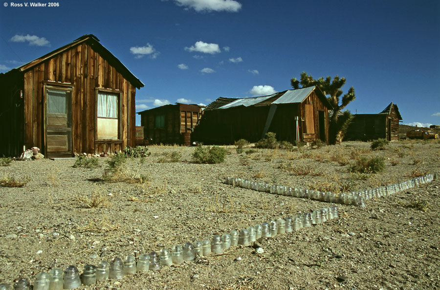 Insulators border the street in front of a row of cabins, Gold Point, Nevada