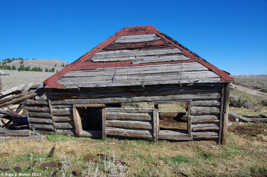 A log house sinks to the windowsills at Gilmore, Idaho.