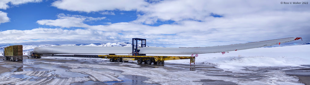 A giant wind turbine blade on a huge truck waits at the Ranch Hand truckstop, Montpelier, Idaho